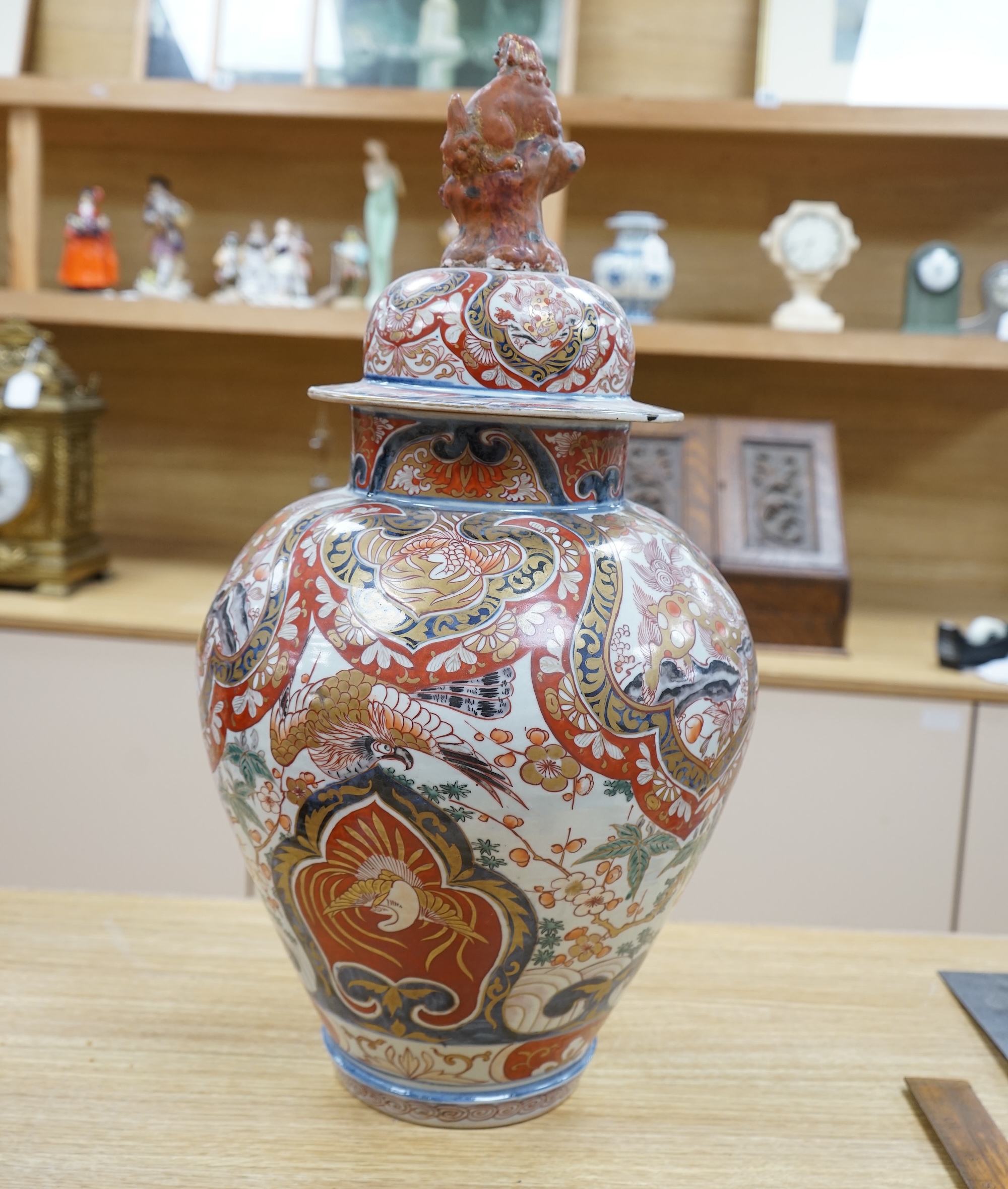 A large 19th century Imari vase with dragon finial to cover, 61cm high. Condition - badly cracked and restored